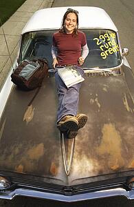 High angle view of a girl leaning over car bonnet