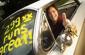Young adult happy with first car