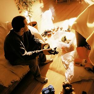 Man surrounded by child's toys