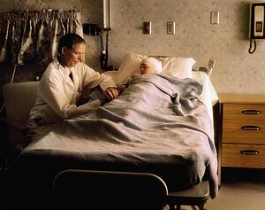 Doctor checking on a child in a hospital room