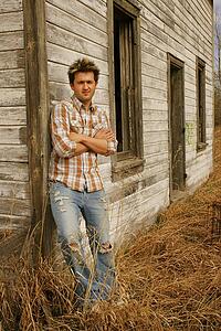 Man leaning against a farm structure