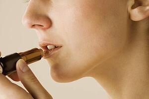 Woman applying lipstick