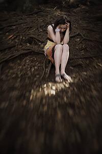 Woman holding head in hands