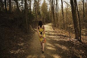 Young woman walking along a path