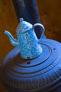Antique coffee pot on pot belly wood stove 