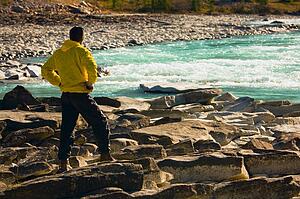 Man overlooking a mountain river 