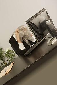 Woman sitting with head down in office