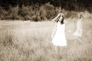 Girl playing in a field of grass