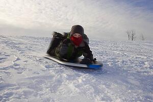Boy tobogganing 