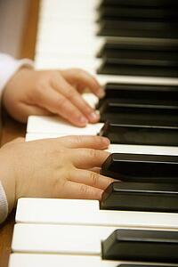 Child's hands playing piano 