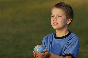 Boy holding a globe in his hands