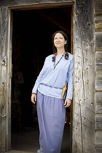 Front view of a woman standing at the door