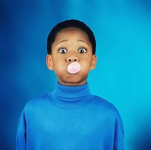 A boy blowing a bubble
