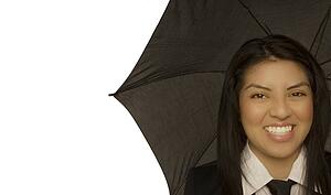 Woman smiling and holding umbrella