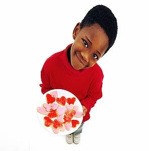 Boy holding plate of heart cookies