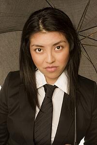 Woman wearing a suit with umbrella