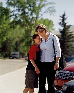 Woman smiling and hugging son