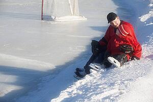 Ice hockey players sitting on snow