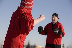 Ice hockey players fighting