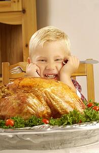 Boy ready to eat cooked turkey