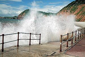Waves crashing against walkway