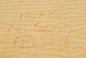 Words in sand that state "we are all God's children"