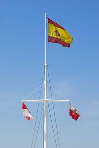 Mast bearing the Spanish national flag and two Cantabrian provincial flags 