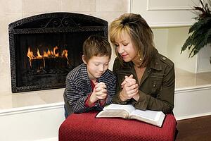 Mother and son praying together