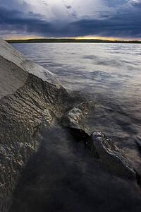Water meeting rock face on lake