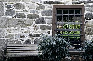 Stone building with bench and window