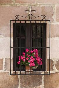 Window with flowers and cross, Carmona, Cantabria, Northern Spain 