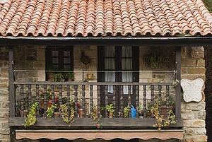 Wooden balcony on stone house in village of Barcena Mayor, Cantabria, Northern Spain