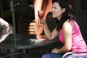 Woman drinking on patio