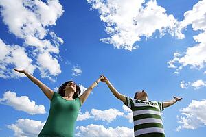 Couple with arms outstretched