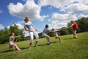 Tug of war between dad and mom with kids