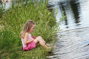 Child playing by the water