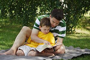 Father reading to his son