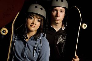 Couple holding skateboards