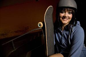 Woman holding skateboard