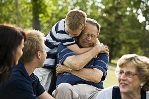 Child hugs grandfather