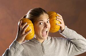 Girl playing with pumpkins 