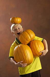 Boy playing with pumpkins 