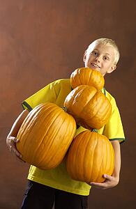 Boy playing with pumpkins 