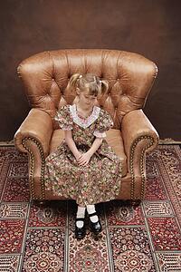 Girl sitting in armchair