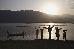 Group of people with arms raised to heaven