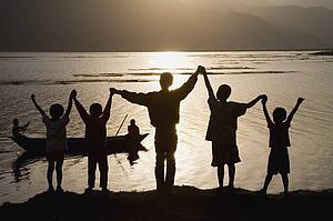 A group of people with arms raised 