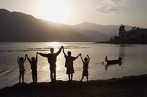 A group of people with arms raised