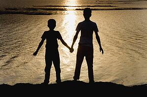 Two boys at the water's edge