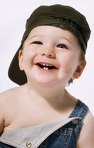 Head and shoulders portrait of a boy laughing