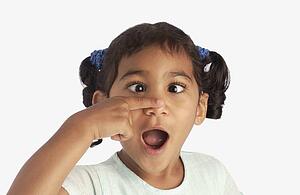 Girl crossing her eyes and touching her nose